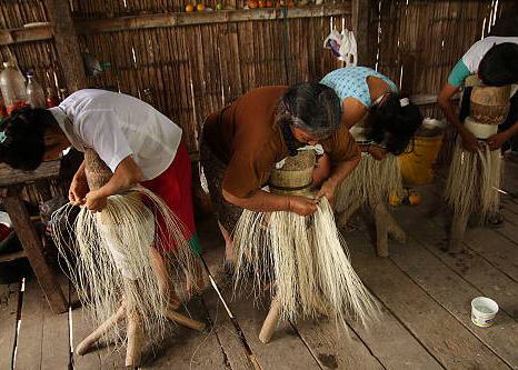 a group of women weaving Toquilla Straw Hats