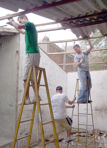 Navy men work on school in Ecuador.